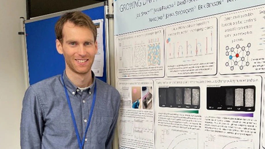 Man in front of poster.